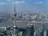 Aerial cityscape of the city of Shanghai with the river and Oriental Pearl Tower in the foreground showing the topography and architecture